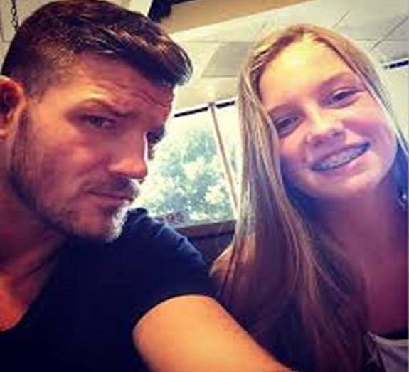 Mike poses with his teenage daughter.